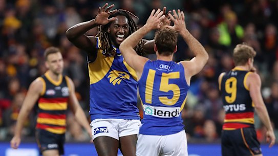 Jamie Cripps of the Eagles celebrates a goal with teammate Nic Naitanui.