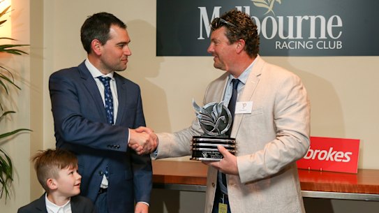 Bill Cockram (right) presents Mick Sharkie with the 2016 Cockram Stakes trophy won by Ocean Embers.