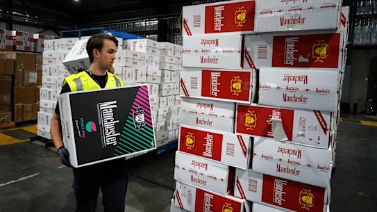 An Australian Border Force officer checks a stash of illegal cigarette imports in Melbourne.
