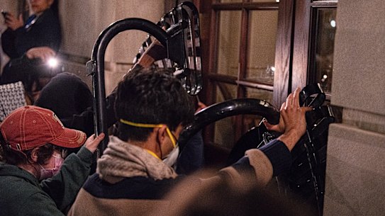 Students with the Gaza solidarity encampment block the entrance of Hamilton Hall.