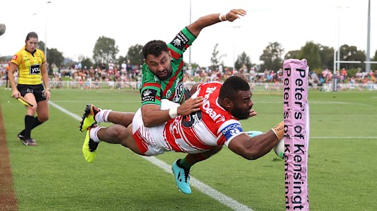 Alex Johnston denies Dragons winger Mikaele Ravalawa a try in the corner on Saturday.