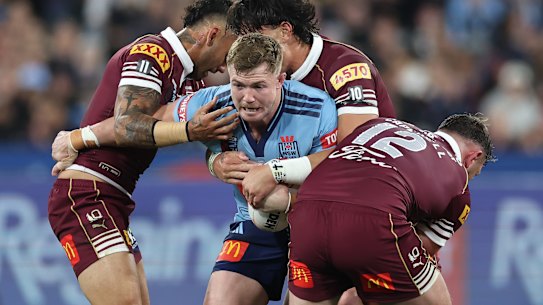 Hudson Young of the Blues is tackled.