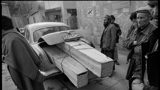 Taxi delivering coffins, Jamhuriat Hospital, Kabul, 1993.
