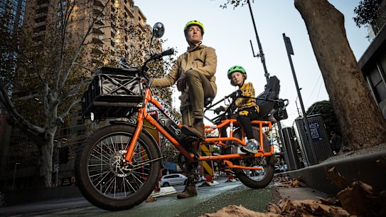 Cyclist Nicholas Tyrrell and his son Ismo, 7.