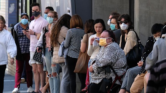 People wait outside the Royal Melbourne Hospital to be tested for coronavirus at a screening clinic on Tuesday.