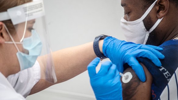 A pharmacist administers the Pfizer COVID-19 vaccination in Jackson, Mississippi. 
