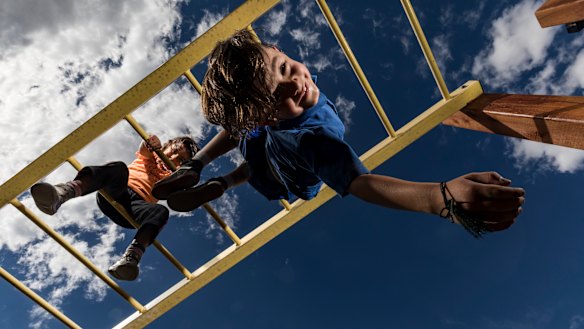 Arlo (7) and Mina (4) love the monkey bars at their local park. Safety experts are calling for monkey bars to be banned, but others argue they keep kids active and get them outside.