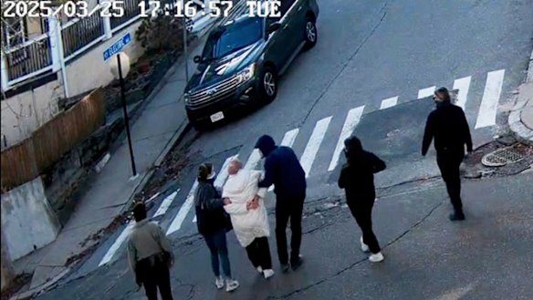 In this image taken from security footage, Rumeysa Ozturk, a 30-year-old doctoral student at Tufts University, is detained by Department of Homeland Security agents on a street in Sommerville, Massachusetts.