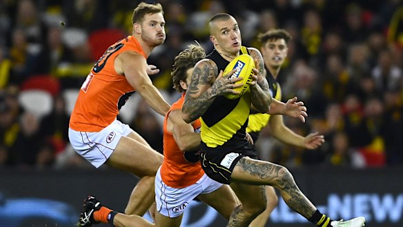 Dustin Martin tries to escape the attentions of Callan Ward.