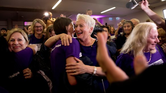 Independent candidate for Wentworth Kerryn Phelps (centre) is congratulated by supporters as she arrives for a Wentworth byelection evening function at North Bondi Life Saving Club.