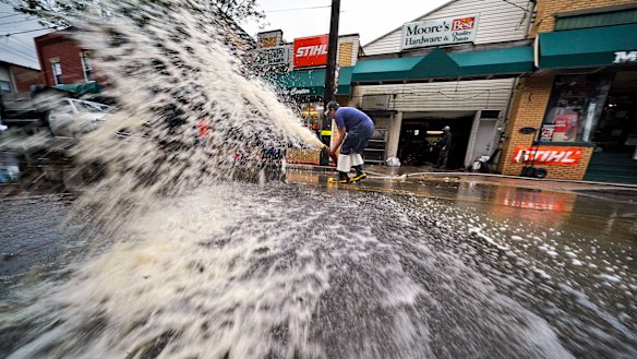 Water is pumped from the basement of a business on Noblestown road in Oakdale, Pennsylvania.