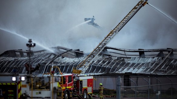Firefighters battle the blaze at e-waste facility MRI E-Cycle on August 9