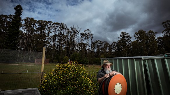 Mark Morrow's Kinglake property is surrounded by  bush and scrub. He has firefighting equipment including hoses on hand.