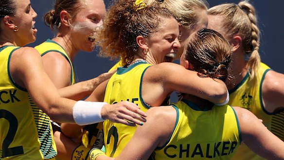 Emily Chalker is hugged by Ambrosia Malone and mobbed by her teammates after scoring yet another goal.