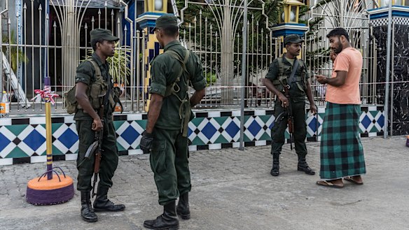 Soldiers stand guard outside the Badhiriy Yah Jum'ah Mosque, in Kattankudy, where Zaharan Hashim worshipped.