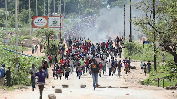 Protesters gather during demonstrations over fuel prices in Harare, Zimbabwe, on Monday. Protesters have blocked roads in some parts in Zimbabwe's capital after the government more than doubled the price of petrol.