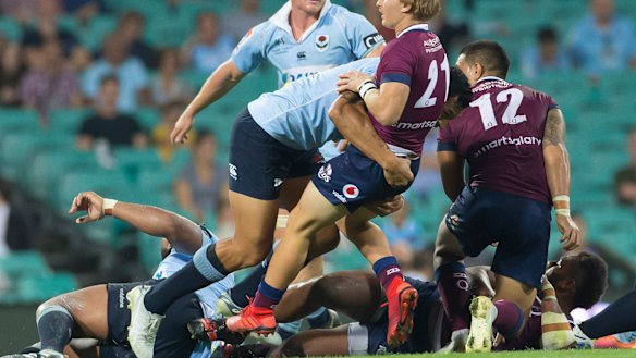 Hardening up: Israel Folau drives back Tate McDermott in the tackle.