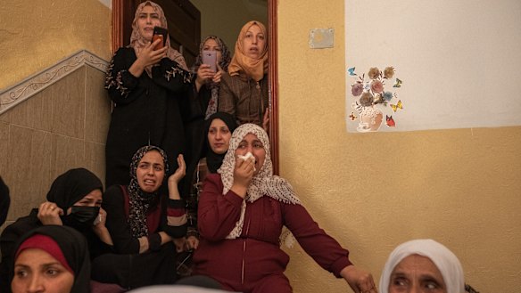 Relatives of Palestinian Ahmed Al-Shenbari, who was killed during an Israeli raid in Beit Hanoun city on the northern Gaza Strip, mourn during his funeral in Gaza City, Gaza. 