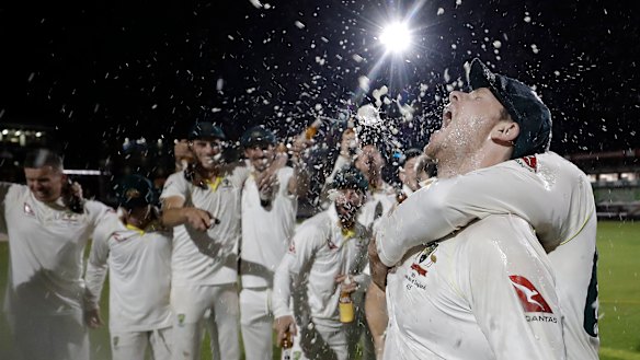 Australian players celebrate retaining the Ashes at Old Trafford.
