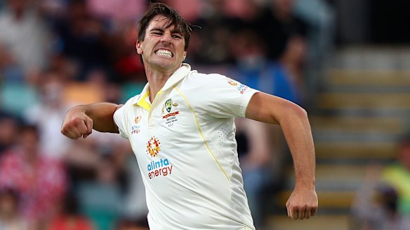 Australia’s Pat Cummins celebrates trapping England’s Joe Root LBW in Hobart.