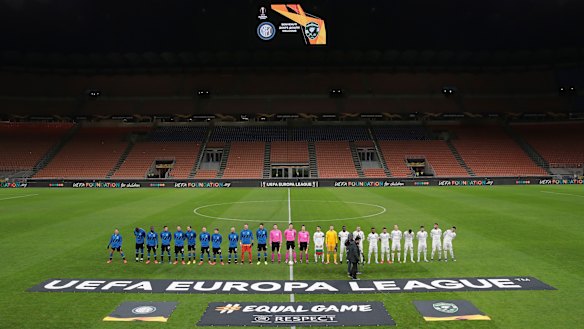 Inter Milan and Ludogorets line up inside the empty San Siro stadium ahead of their Europa League round-of-32 match.