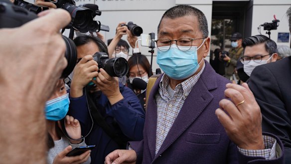 Founder of Hong Kong's Apple Daily newspaper, Jimmy Lai, walks out from a police station after being bailed out in Hong Kong.