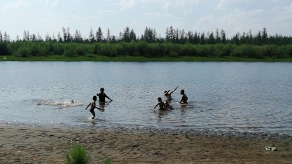 Children play in the Krugloe lake outside Verkhoyansk - the Siberian town that endures the world's widest temperature range, which has recorded a new high amid a heatwave that is contributing to severe forest fires. 