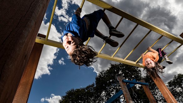 Arlo (8) and Mina (4) love the monkey bars at their local park in Footscray. 