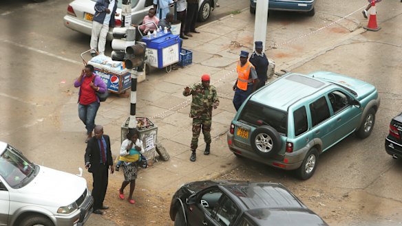 A soldier controls a fuel queue in Harare on Tuesday. 