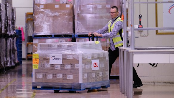 A worker rolls a batch of AstraZeneca vaccines onto a truck at a CSL factory in Melbourne. 