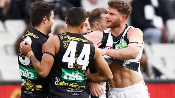 Trent Cotchin and Taylor Adams test the durability of each other’s jumpers out. 