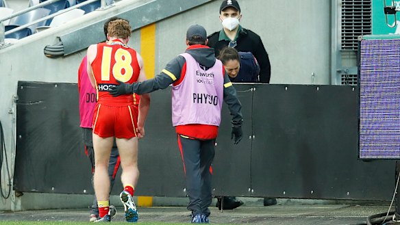 The youngster is escorted from the field.