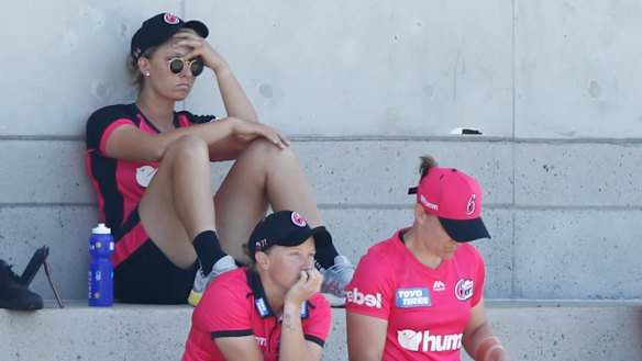 Ash Gardner nurses a sore head after being forced out of the WBBL match against Adelaide at Drummoyne Oval.