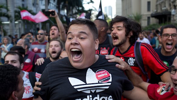 Soccer fans and supporters of Workers' Party presidential candidate Fernando Haddad shout slogans during a demonstration at Cinelandia square, Rio de Janeiro, Brazil.