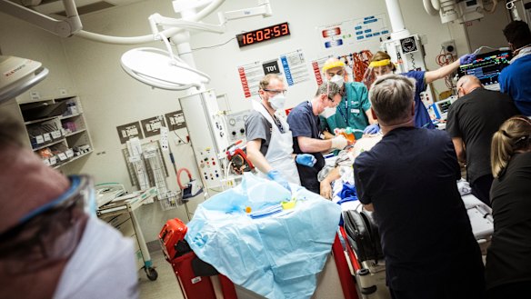 A man brought into the emergency department under cardiac arrest is worked on at the Royal Melbourne Hospital. 