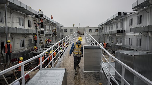 Workers put the finishing touches on the Wuhan Huoshenshan Hospital on Sunday.
