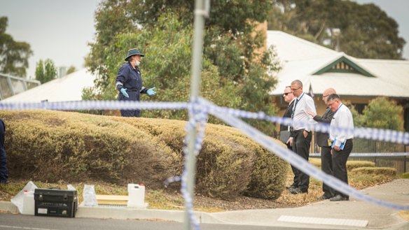 Crime scene investigators speak to senior Victoria Police at the scene where a body was found in Bundoora. 