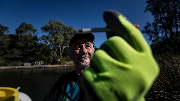 Yarra Riverkeeper Andrew Kelly picks up one of the estimated tens of thousands of syringes that are lying in the Yarra and its river beds. 