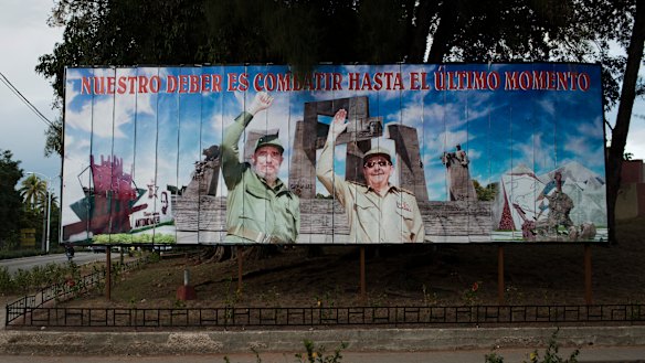 A billboard featuring Fidel and Raul Castro, reading “Our duty is to fight until the last moment,” in Holquin, Cuba, in  2014.