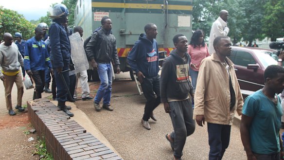Dozens of protesters arrive at court in Harare on Wednesday.