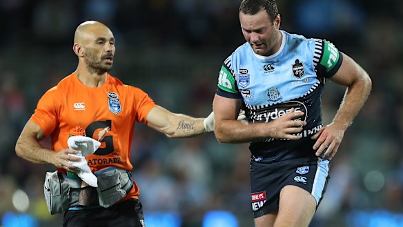 Boyd Cordner is assisted off Adelaide Oval for a head injury assessment.
