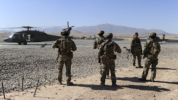 SAS soldiers on duty in Afghanistan move towards a waiting UH-60 Blackhawk helicopter.