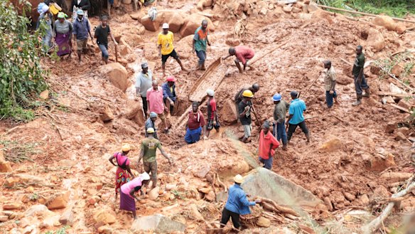 A family dig for their son who was buried in the mud when Cyclone Idai struck in Chimanimani about 600 kilometres south east of Harare, Zimbabwe, on Tuesday.