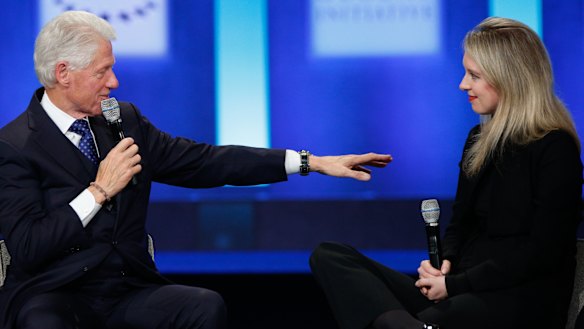 Holmes (pictured here with former US president Bill Clinton) rubbed shoulders with political and business elite before her world came crashing down.