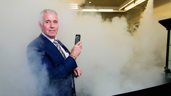 Jeweller Garry Holloway tests his smoke security system.