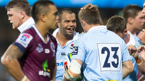 Rivalry: Kurtley Beale congratulates Alex Newsome on scoring a try against Queensland in round four. 