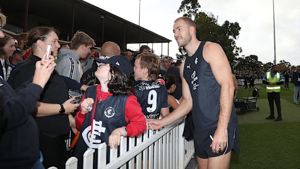 Blues star Harry McKay poses for photos with fans during a Carlton training session at Unley Oval ahead of Gather Round.