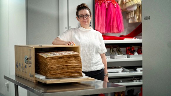 APAC curator Sandra Bruce with the 500-page scrapbook documenting the history of the circus.