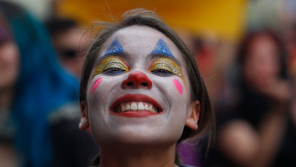 A woman made up as a clown poses during the eighth day of protests against President Sebastian Piñera's government. 