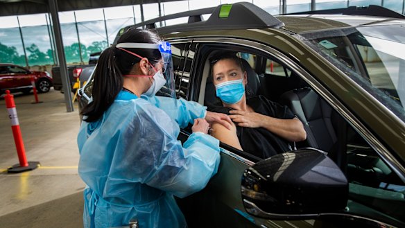 Health worker Khanh Tran  gives Nicolette Kolozsi her first Pfizer jab on Sunday at the drive-through clinic, which will officially open on Monday.

